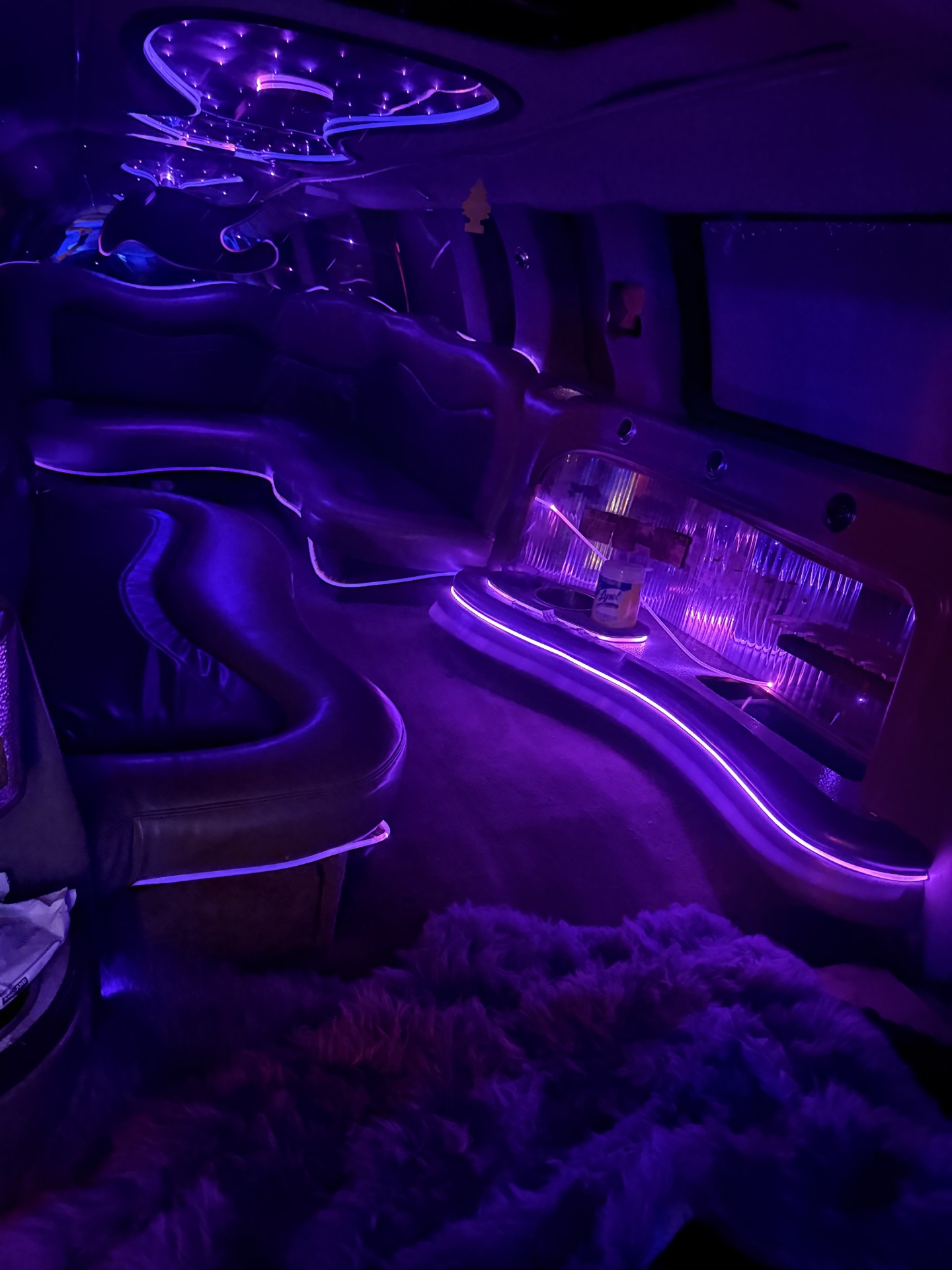 Purple-lit luxury limousine interior available for private events