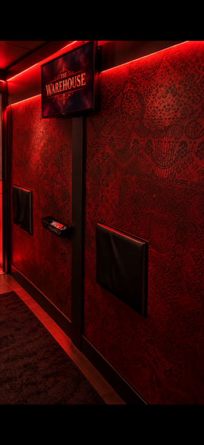 Red-lit patterned corridor inside The Warehouse